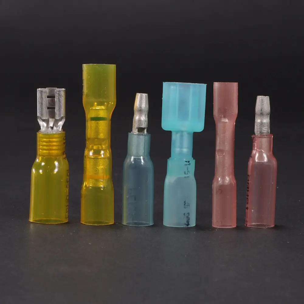 Various heat seal products lined up showing the variety on a black background; Power Connectors Decorative Image