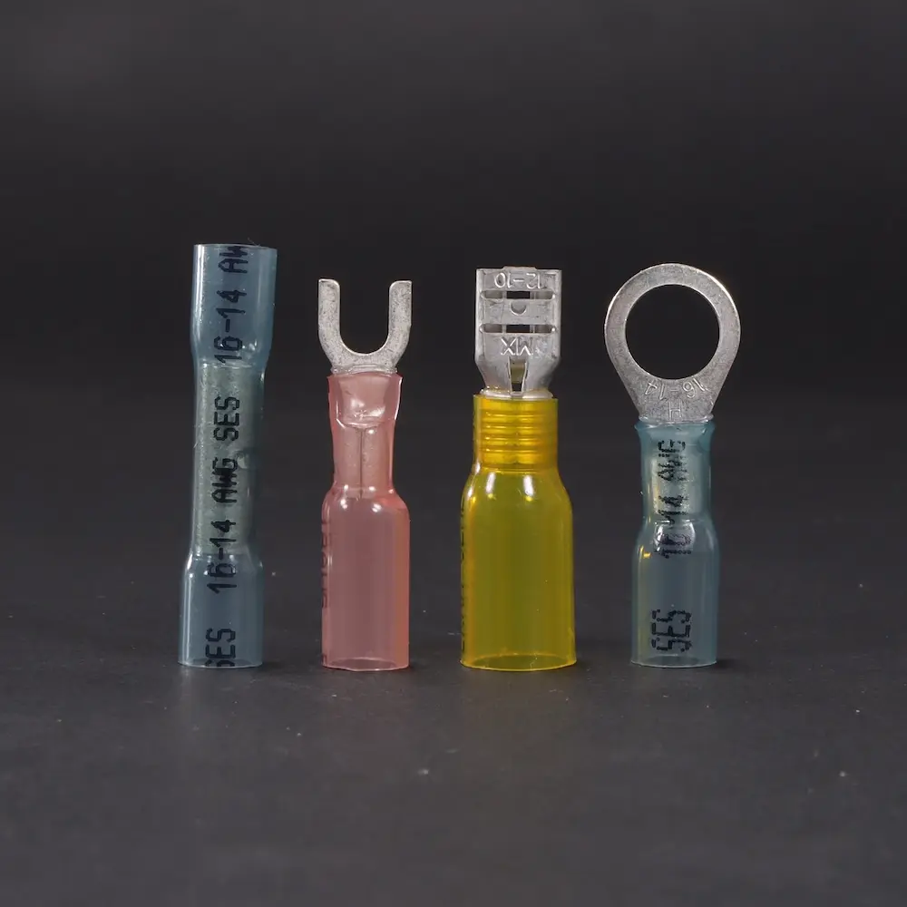 Various heat seal products lined up showing the variety on a black background; Power Connectors Decorative Image